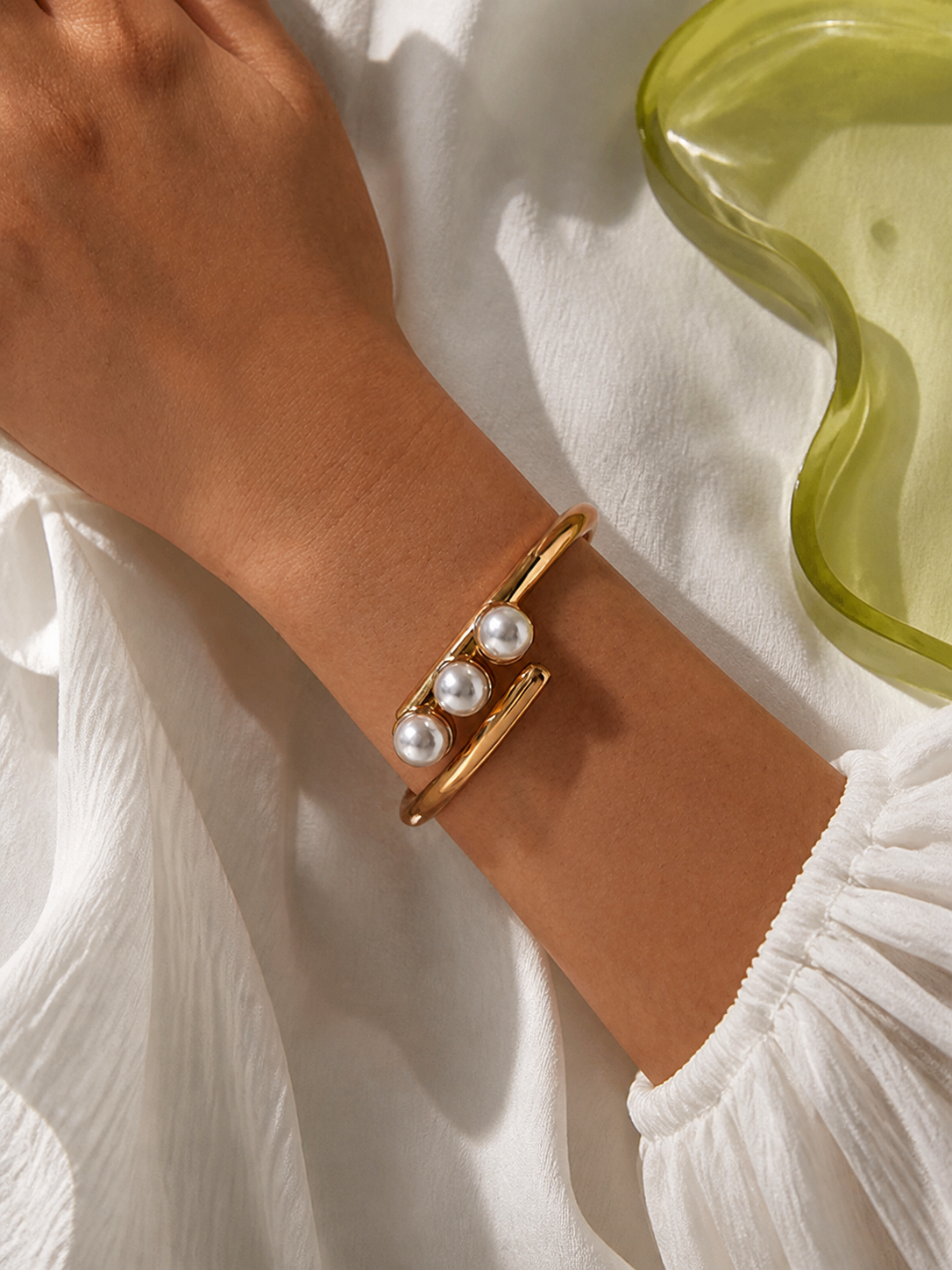 Lisa Olive pearl cuff bracelet worn on wrist