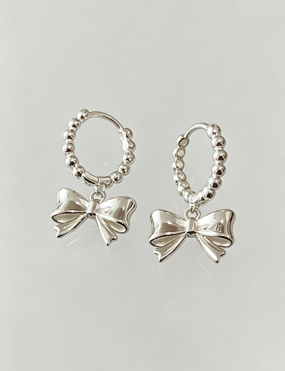 Bow Knot Huggie Hoop Earrings — silver earrings